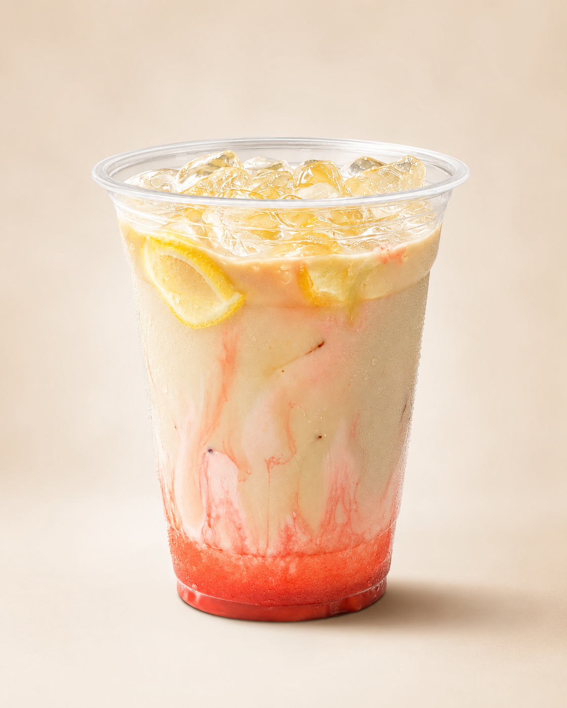 Cold drink in a clear cup with red and citrus-colored details